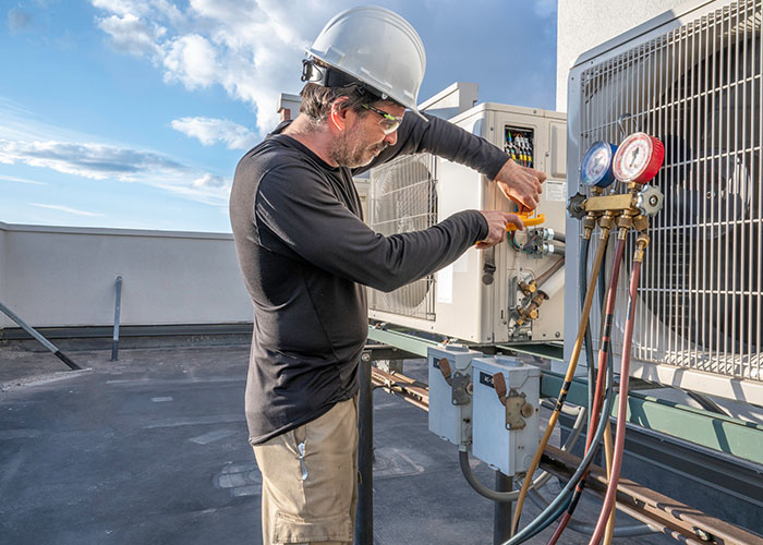 HVAC technician hooking up amp clamp